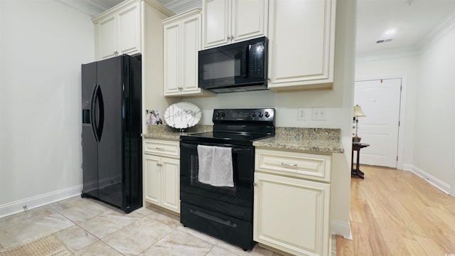 130 Puffin Dr Unit 2B, Pawleys Island, SC 29585 - kitchen featuring black appliances, crown molding, light stone counters, light wood-type flooring, and cream cabinets