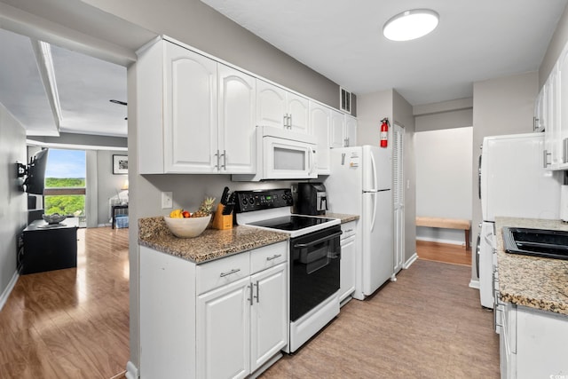 400 20th Ave N Unit 606, Myrtle Beach, SC 29577 - kitchen with white appliances, light wood-type flooring, white cabinets, and light stone countertops