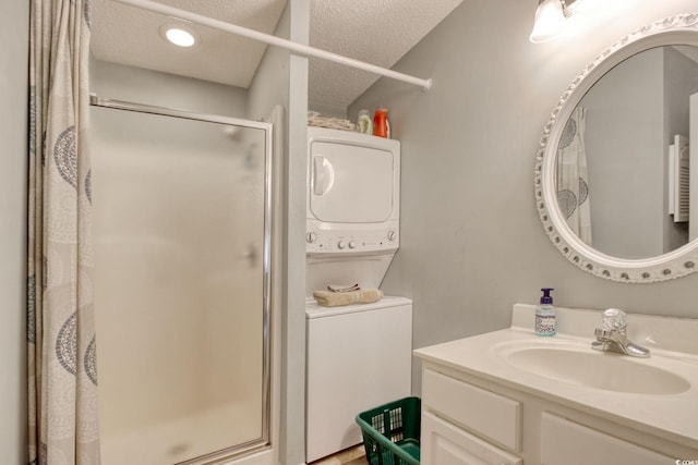 23 Robert Conway Ct, Georgetown, SC 29440 - full bathroom with stacked washing machine and dryer, a stall shower, vanity, and a textured ceiling