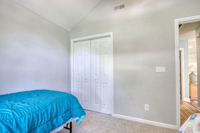 23 Robert Conway Ct, Georgetown, SC 29440 - bedroom featuring vaulted ceiling, carpet floors, a closet, and a textured ceiling