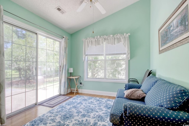 23 Robert Conway Ct, Georgetown, SC 29440 - living area featuring lofted ceiling, wood finished floors, healthy amount of natural light, a ceiling fan, and a textured ceiling