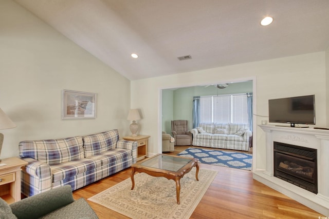 23 Robert Conway Ct, Georgetown, SC 29440 - living area with lofted ceiling, wood finished floors, recessed lighting, and a glass covered fireplace