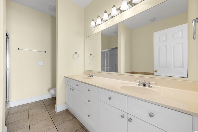 817 S Ocean Blvd Unit 201, North Myrtle Beach, SC 29582 - bathroom with double vanity, tile patterned flooring, and a shower with door