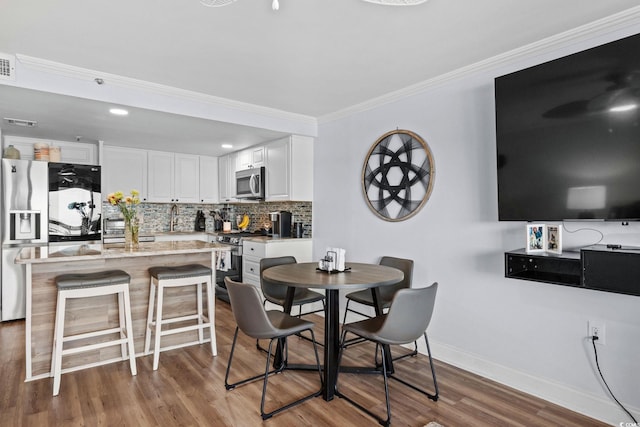 5511 N Ocean Blvd Unit 902, Myrtle Beach, SC 29577 - dining space with ornamental molding and wood finished floors