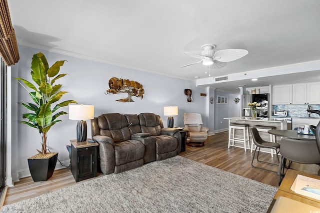 5511 N Ocean Blvd Unit 902, Myrtle Beach, SC 29577 - living room with light wood-style floors, ceiling fan, and crown molding