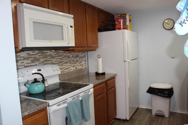 1025 Plantation Dr W Unit 2625/2626, Little River, SC 29566 - kitchen featuring white appliances, decorative backsplash, brown cabinetry, dark wood finished floors, and a textured ceiling