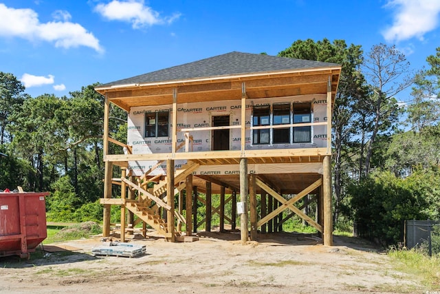 196 Brown Pelican Loop, Pawleys Island, SC 29585 - back of house featuring roof with shingles and a carport