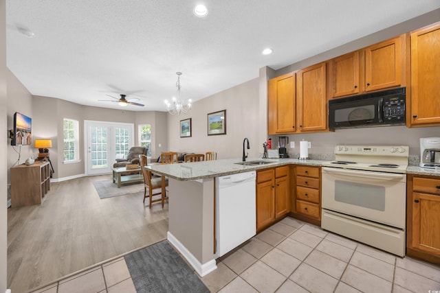 4502 Ailsa Ct Unit B, Conway, SC 29526 - kitchen featuring white appliances, open floor plan, a peninsula, a chandelier, and a ceiling fan