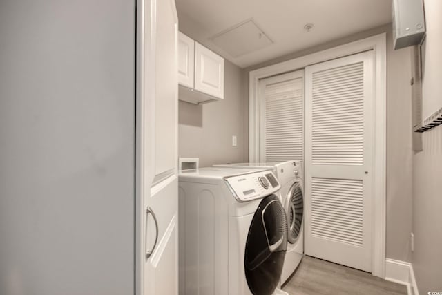2180 Waterview Dr Unit 721, North Myrtle Beach, SC 29582 - washroom with cabinet space, washing machine and dryer, and light wood finished floors