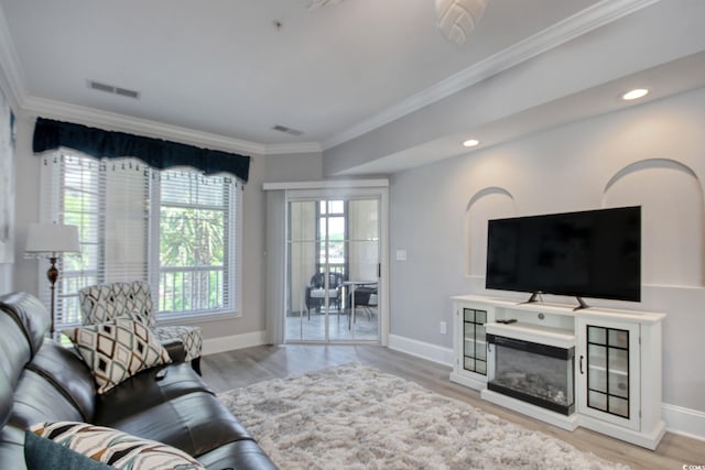 2180 Waterview Dr Unit 721, North Myrtle Beach, SC 29582 - living room with crown molding, wood finished floors, recessed lighting, and a glass covered fireplace