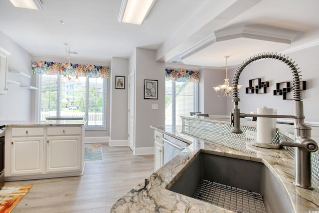 2180 Waterview Dr Unit 721, North Myrtle Beach, SC 29582 - kitchen featuring light wood-type flooring, light stone countertops, white cabinetry, a chandelier, and decorative light fixtures