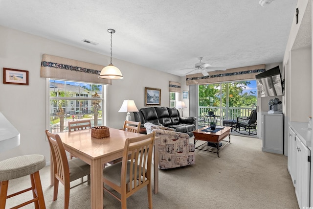 493 White River Dr Unit 28-D, Myrtle Beach, SC 29579 - dining area with ceiling fan, light carpet, and a textured ceiling