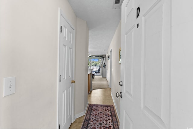 493 White River Dr Unit 28-D, Myrtle Beach, SC 29579 - corridor with a textured ceiling and baseboards