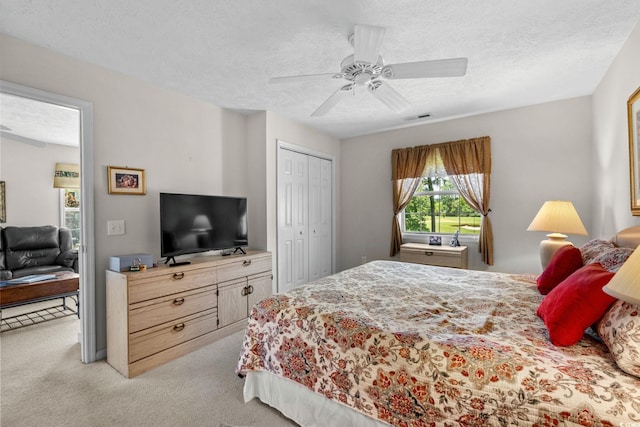 493 White River Dr Unit 28-D, Myrtle Beach, SC 29579 - bedroom with light colored carpet, a textured ceiling, a ceiling fan, and a closet