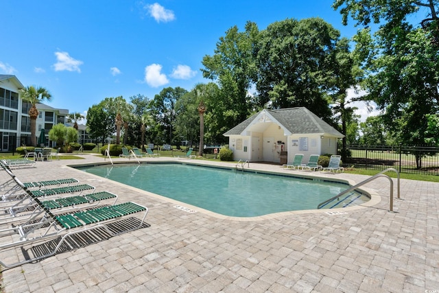 493 White River Dr Unit 28-D, Myrtle Beach, SC 29579 - community pool featuring a patio and view of scattered trees
