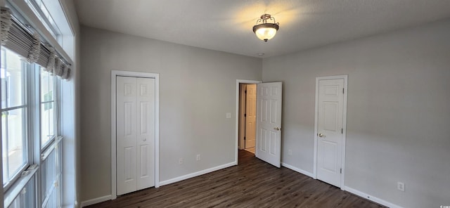 134 Scotch Broom Dr Unit K-203, Little River, SC 29566 - unfurnished bedroom with dark wood-type flooring and a closet