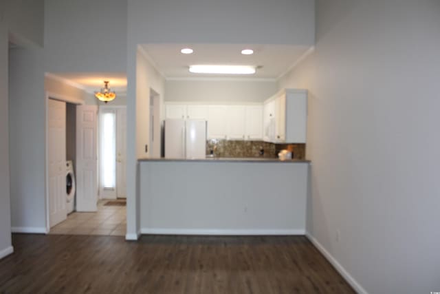 134 Scotch Broom Dr Unit K-203, Little River, SC 29566 - unfurnished living room featuring wood finished floors, washer / dryer, recessed lighting, and ornamental molding