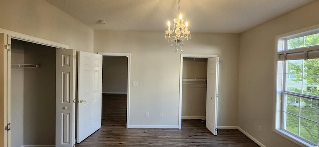 134 Scotch Broom Dr Unit K-203, Little River, SC 29566 - unfurnished bedroom featuring a chandelier, dark wood-style floors, and a closet
