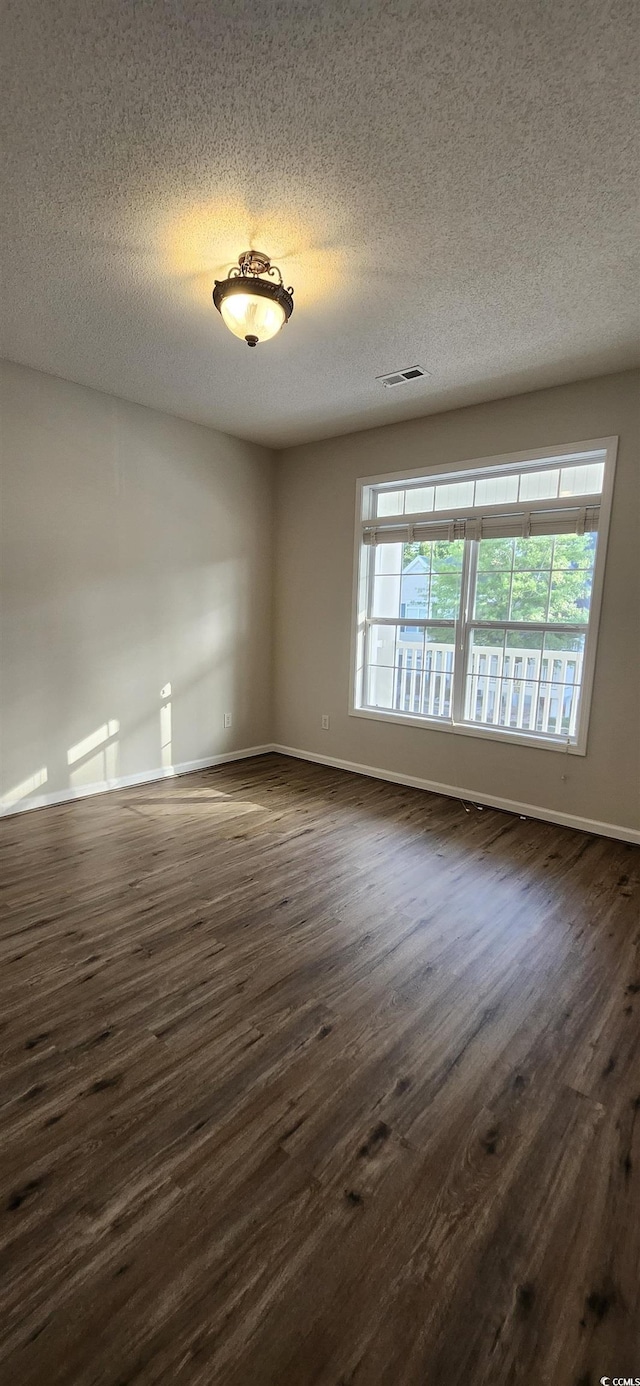 134 Scotch Broom Dr Unit K-203, Little River, SC 29566 - spare room with dark wood finished floors, a textured ceiling, and healthy amount of natural light