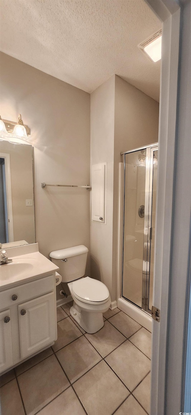 134 Scotch Broom Dr Unit K-203, Little River, SC 29566 - bathroom with a shower stall, vanity, tile patterned floors, and a textured ceiling