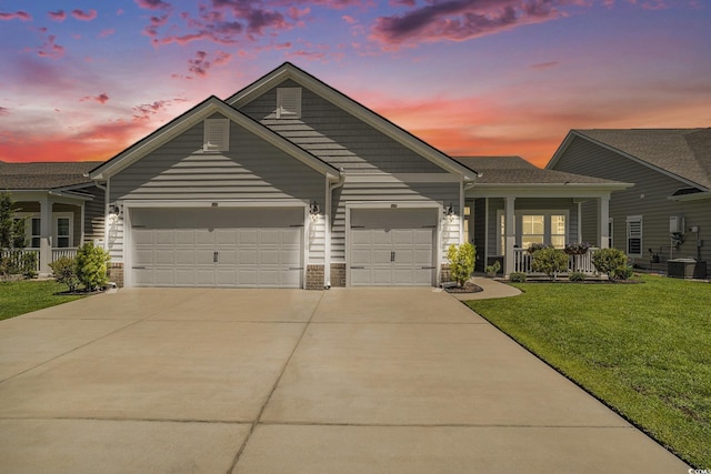 860 Brant St, Myrtle Beach, SC 29579 - view of front of property with an attached garage, a porch, a yard, and concrete driveway
