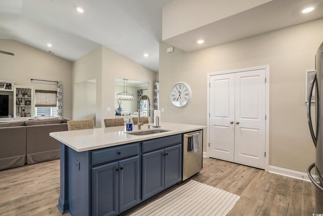 860 Brant St, Myrtle Beach, SC 29579 - kitchen featuring appliances with stainless steel finishes, lofted ceiling, light wood-style floors, blue cabinetry, and open floor plan