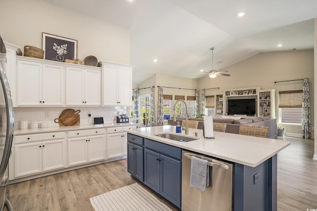 860 Brant St, Myrtle Beach, SC 29579 - kitchen with stainless steel appliances, blue cabinets, white cabinetry, vaulted ceiling, and open floor plan