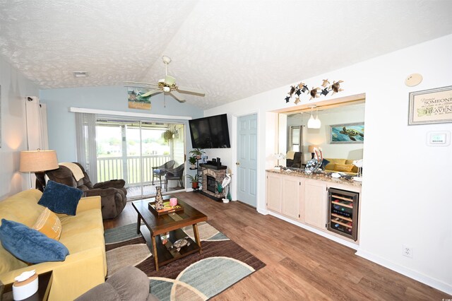 697 Tupelo Ln Unit 24G, Longs, SC 29568 - living room with wine cooler, wood finished floors, vaulted ceiling, a textured ceiling, and a ceiling fan