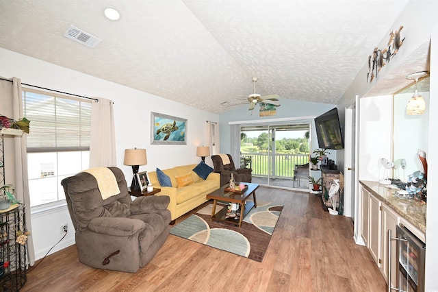 697 Tupelo Ln Unit 24G, Longs, SC 29568 - living area with a textured ceiling, wood finished floors, vaulted ceiling, ceiling fan, and wine cooler