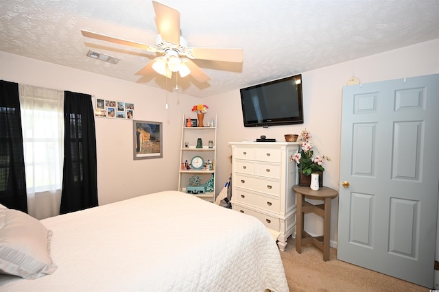 697 Tupelo Ln Unit 24G, Longs, SC 29568 - bedroom with light colored carpet, a textured ceiling, and a ceiling fan