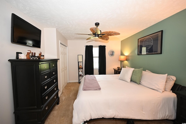 697 Tupelo Ln Unit 24G, Longs, SC 29568 - bedroom with light colored carpet, ceiling fan, a closet, and a textured ceiling