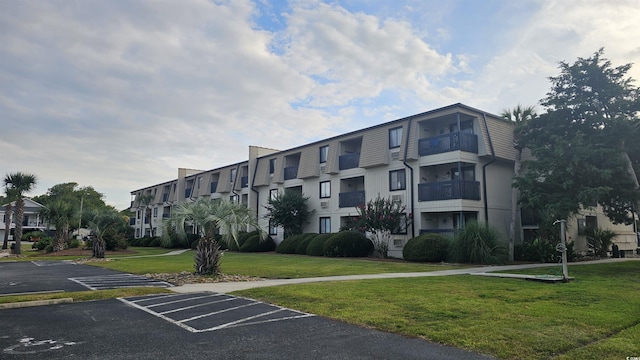 405 21st Ave S Unit 2J, North Myrtle Beach, SC 29582 - view of building exterior with uncovered parking and a residential view