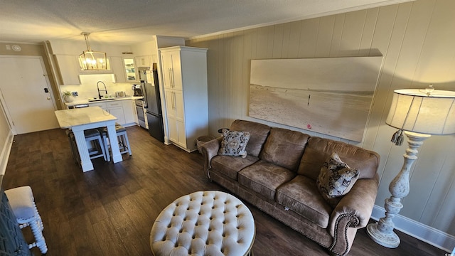 405 21st Ave S Unit 2J, North Myrtle Beach, SC 29582 - living area featuring dark wood finished floors, a chandelier, and crown molding