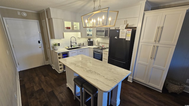 405 21st Ave S Unit 2J, North Myrtle Beach, SC 29582 - kitchen featuring stainless steel appliances, dark wood-type flooring, a chandelier, white cabinets, and a textured ceiling