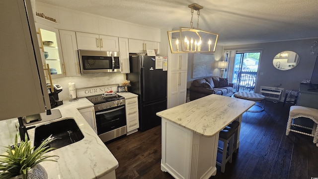 405 21st Ave S Unit 2J, North Myrtle Beach, SC 29582 - kitchen featuring appliances with stainless steel finishes, crown molding, open floor plan, a chandelier, and dark wood-style flooring