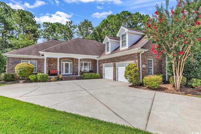 4507 Smilax Pl, Murrells Inlet, SC 29576 - view of front facade featuring brick siding, a porch, concrete driveway, a garage, and roof with shingles