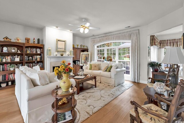 4507 Smilax Pl, Murrells Inlet, SC 29576 - living area with a ceiling fan, light wood-type flooring, and a fireplace