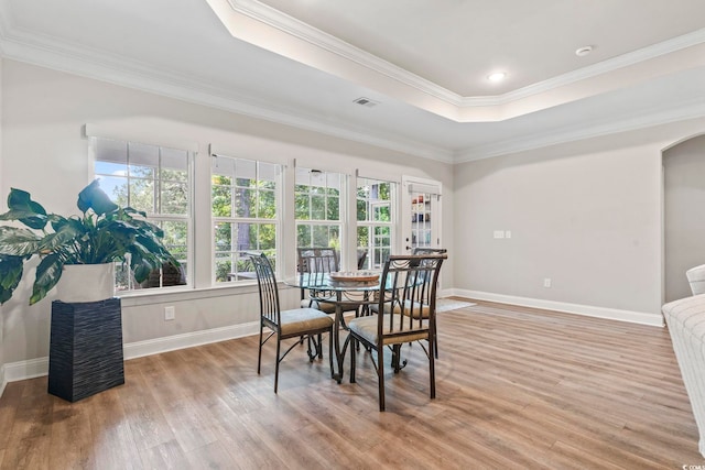 4002 Bayfield Loop, Murrells Inlet, SC 29576 - dining space with a tray ceiling, light wood finished floors, arched walkways, and crown molding