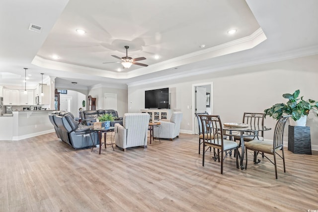 4002 Bayfield Loop, Murrells Inlet, SC 29576 - living room with a tray ceiling, a ceiling fan, ornate columns, light wood finished floors, and ornamental molding