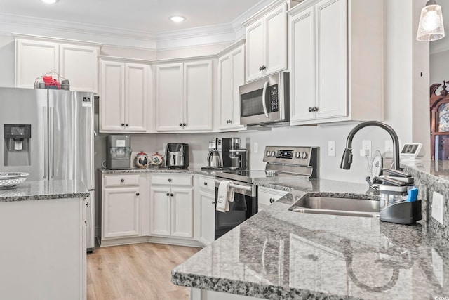 4002 Bayfield Loop, Murrells Inlet, SC 29576 - kitchen featuring stainless steel appliances, white cabinetry, crown molding, light wood-style floors, and light stone counters