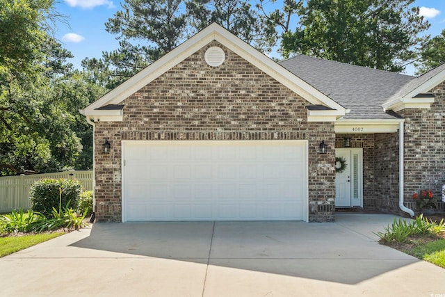 4002 Bayfield Loop, Murrells Inlet, SC 29576 - view of front of house with a garage, driveway, brick siding, and roof with shingles