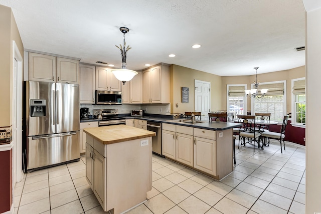 16 Calabash Dr, Carolina Shores, NC 28467 - kitchen featuring appliances with stainless steel finishes, wooden counters, a peninsula, recessed lighting, and a chandelier