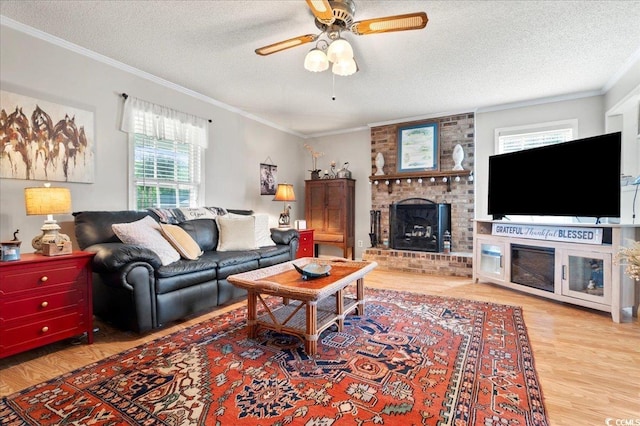 322 Azalea Ave, Marion, SC 29571 - living room featuring a fireplace, crown molding, wood finished floors, a textured ceiling, and ceiling fan