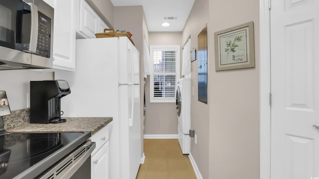 521 White River Dr Unit 21C, Myrtle Beach, SC 29579 - kitchen featuring stainless steel appliances, light tile patterned floors, and white cabinets