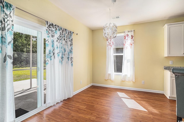 737 Lafayette Park Dr, Little River, SC 29566 - unfurnished dining area featuring wood finished floors and a chandelier