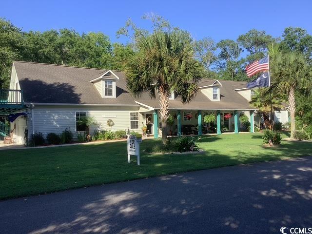 390 Boundary Ave, Murrells Inlet, SC 29576 - cape cod home featuring a front yard