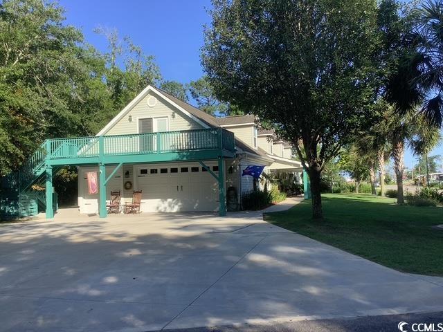 390 Boundary Ave, Murrells Inlet, SC 29576 - view of front of home with a garage, a front lawn, driveway, stairway, and a deck