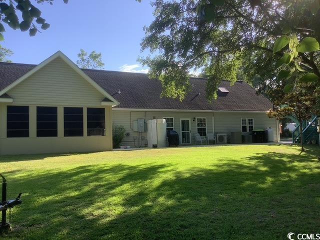 390 Boundary Ave, Murrells Inlet, SC 29576 - back of property featuring a lawn and a shingled roof