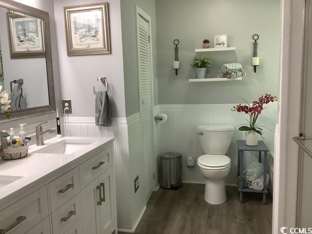 390 Boundary Ave, Murrells Inlet, SC 29576 - full bathroom with a wainscoted wall, double vanity, wood finished floors, and a closet
