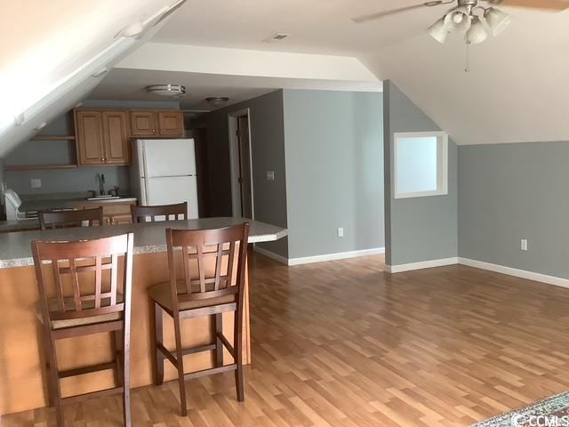 390 Boundary Ave, Murrells Inlet, SC 29576 - kitchen with freestanding refrigerator, a kitchen bar, ceiling fan, light wood finished floors, and open shelves